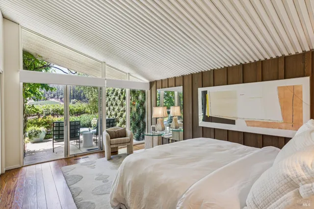 a bedroom with bed and a wooden floor