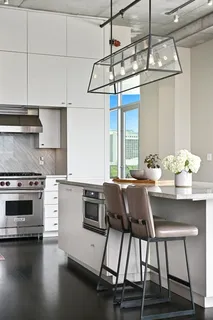 a kitchen with a table chairs stove and cabinets