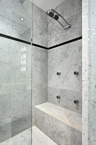 a bathroom with a shower and a mirror