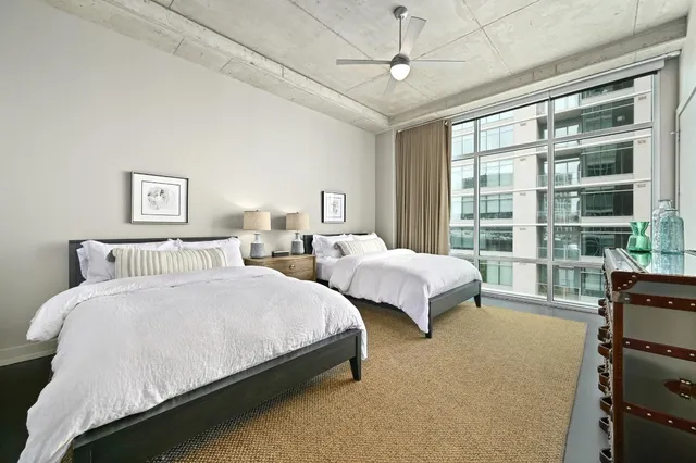a bedroom with two beds and a chandelier
