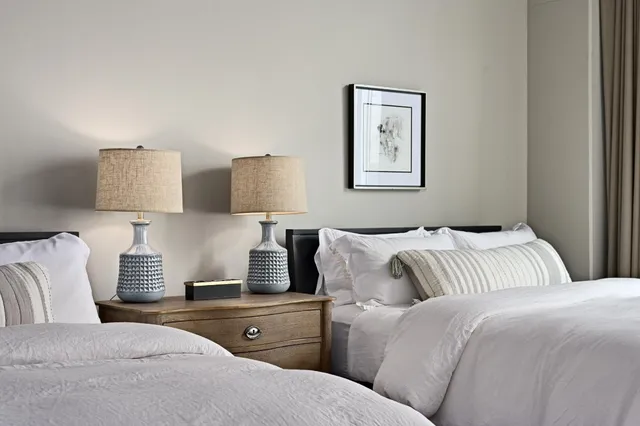 a bedroom with a bed and lamp