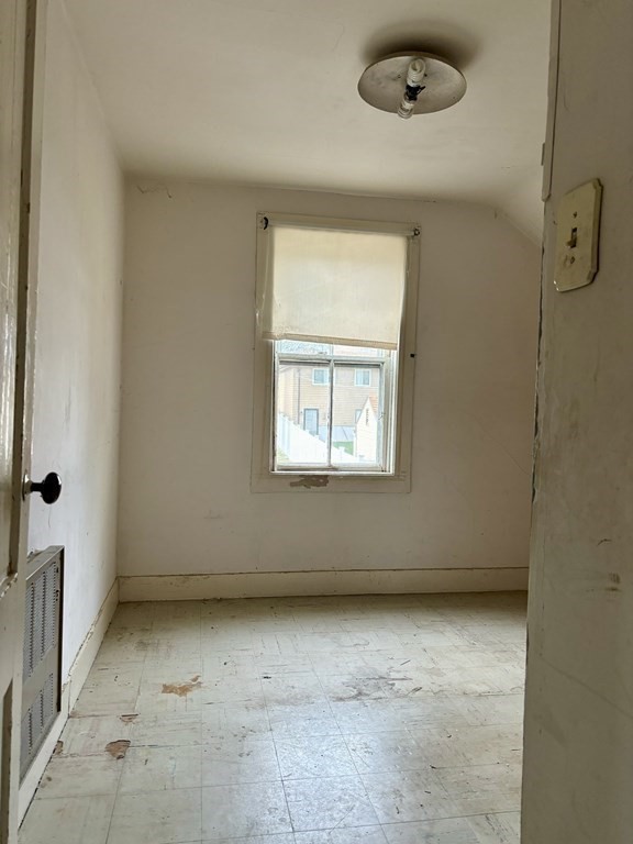 91 Smith Street Fall River, MA 02721 - Photo 18 of 23 an empty room with a empty space and windows
