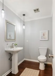 a bathroom with a sink toilet and a mirror