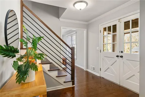 a view of an entryway with wooden floor and front door