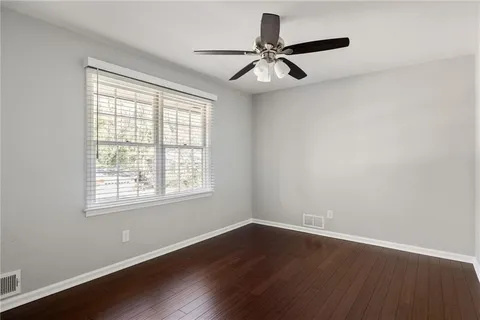 a view of a room with wooden floor and windows