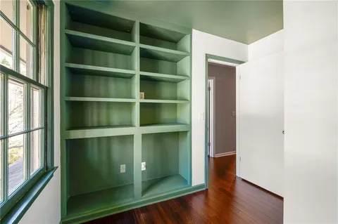 a room with walk in closet and wooden floor