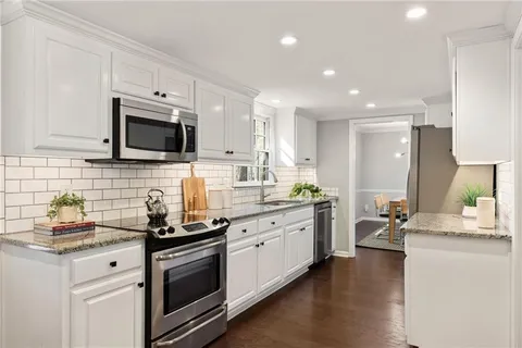 a kitchen with a sink stove and microwave