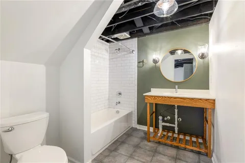 a bathroom with a toilet a sink and bathtub