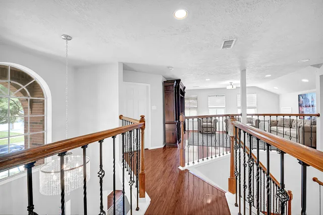 a view of staircase with wooden floor