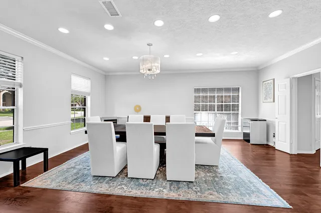 a living room with furniture a window and wooden floor