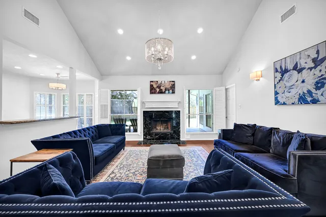 a living room with furniture ceiling fan and a fireplace