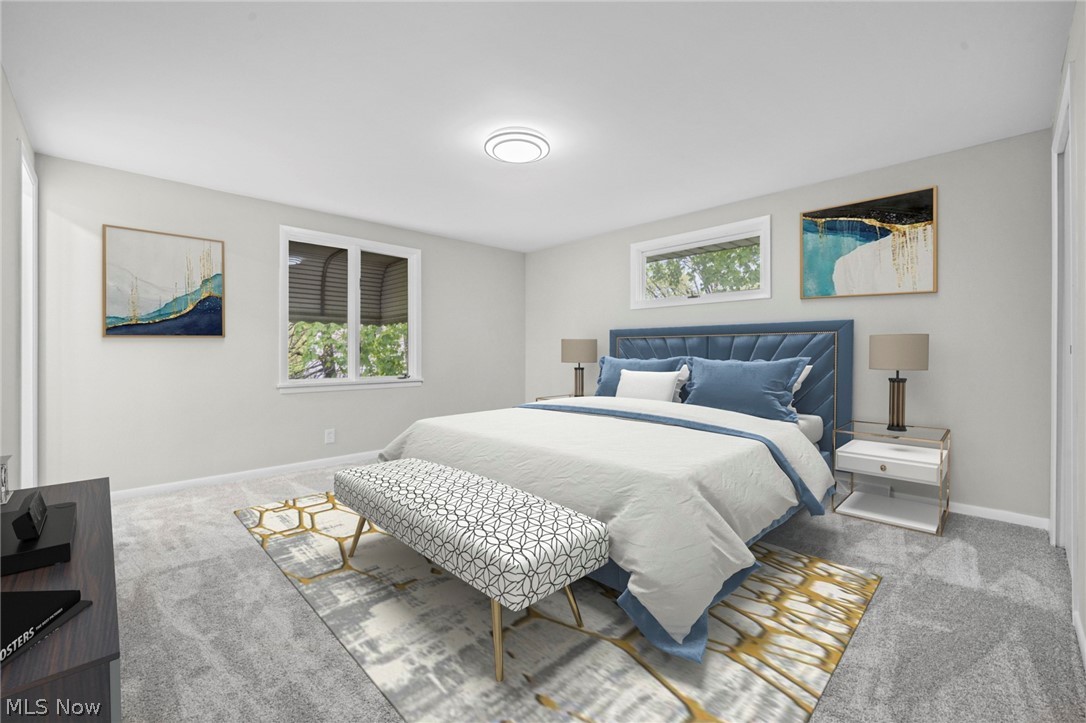 2375 Glendon Road University Heights, OH 44118 - Photo 25 of 50 Bright bedroom featuring light gray carpeting, neutral wall tones, and two windows providing natural light