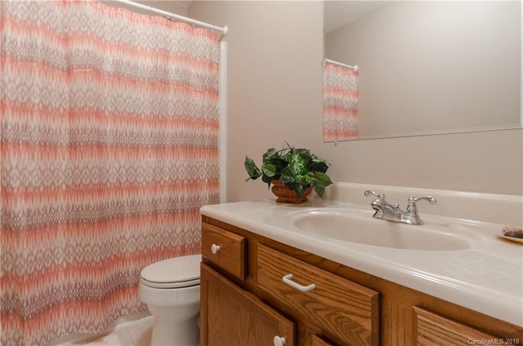 2110 State Rd S-46-168, Unit 25 York, SC 29745 - Photo 13 of 31 a bathroom with a sink a toilet and mirror