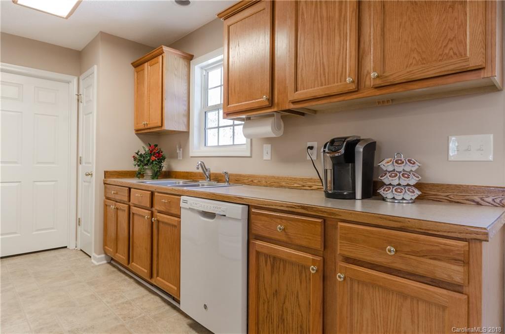 2110 State Rd S-46-168, Unit 25 York, SC 29745 - Photo 4 of 31 a kitchen with stainless steel appliances granite countertop a sink cabinets and a window