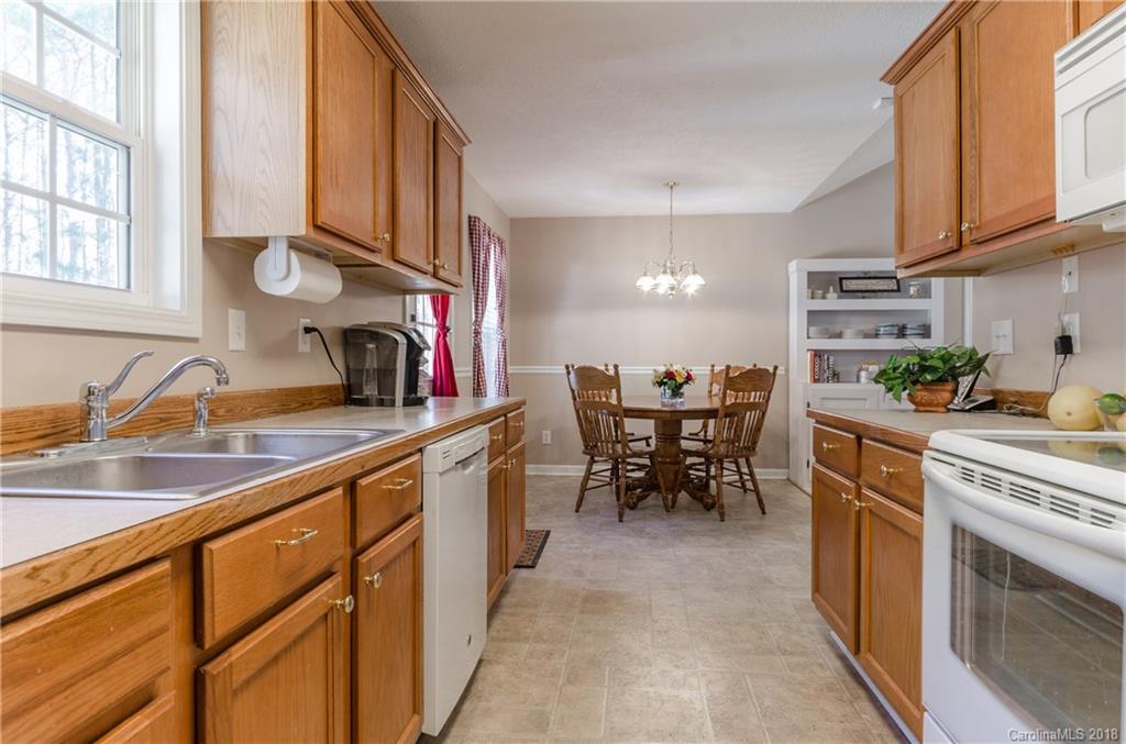2110 State Rd S-46-168, Unit 25 York, SC 29745 - Photo 6 of 31 a kitchen with stainless steel appliances granite countertop a sink and a refrigerator