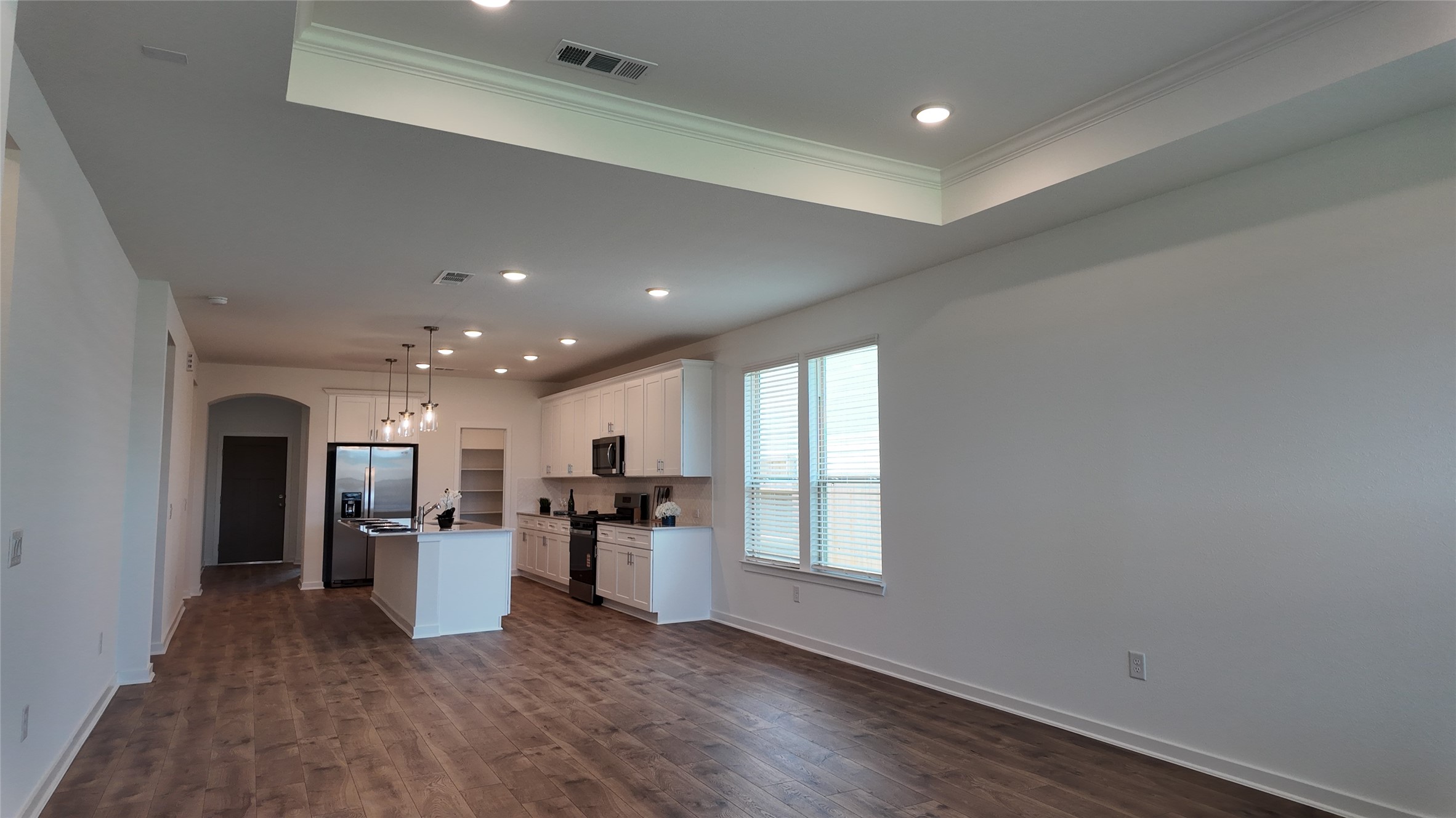 15645 Wandering Maple Way Conroe, TX 77302 - Photo 8 of 14 a view of kitchen with wooden floor and electronic appliances