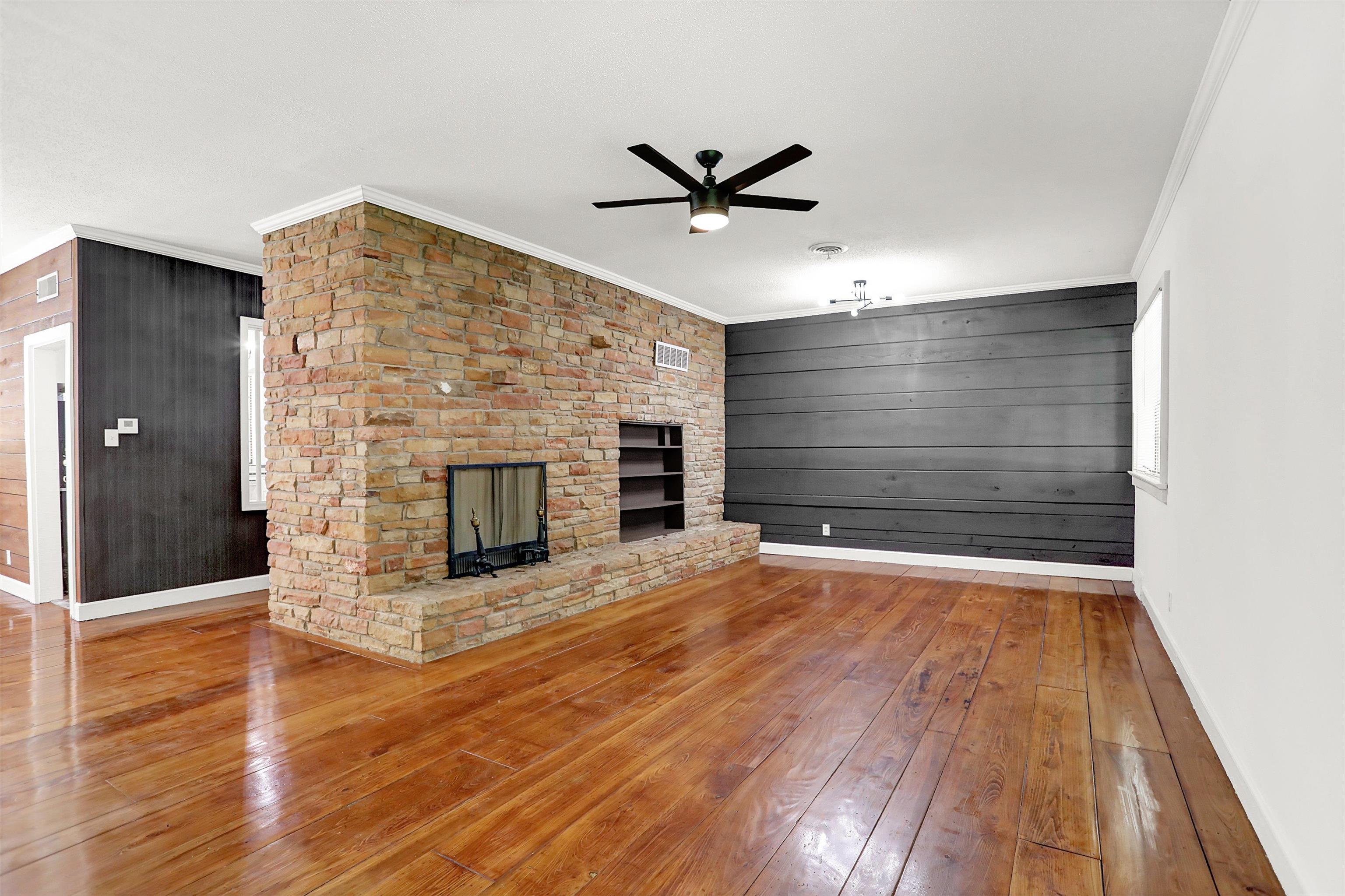 3618 Prescott Road Memphis, TN 38118 - Photo 7 of 20 a view of a livingroom with wooden floor and a fireplace