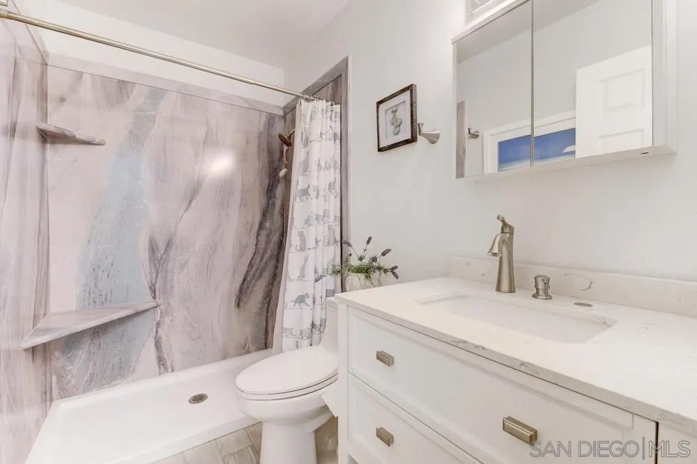 13008 Acton Avenue Poway, CA 92064 - Photo 13 of 28 a bathroom with a sink toilet and shower