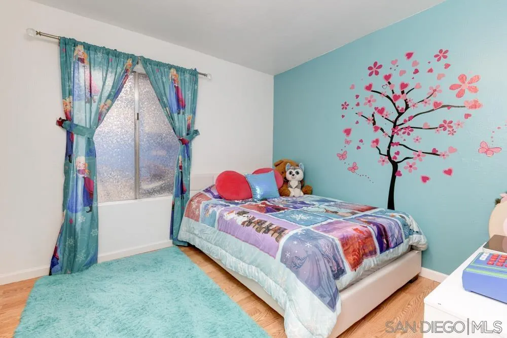 13008 Acton Avenue Poway, CA 92064 - Photo 14 of 28 a bedroom with a bed and a painting on the wall