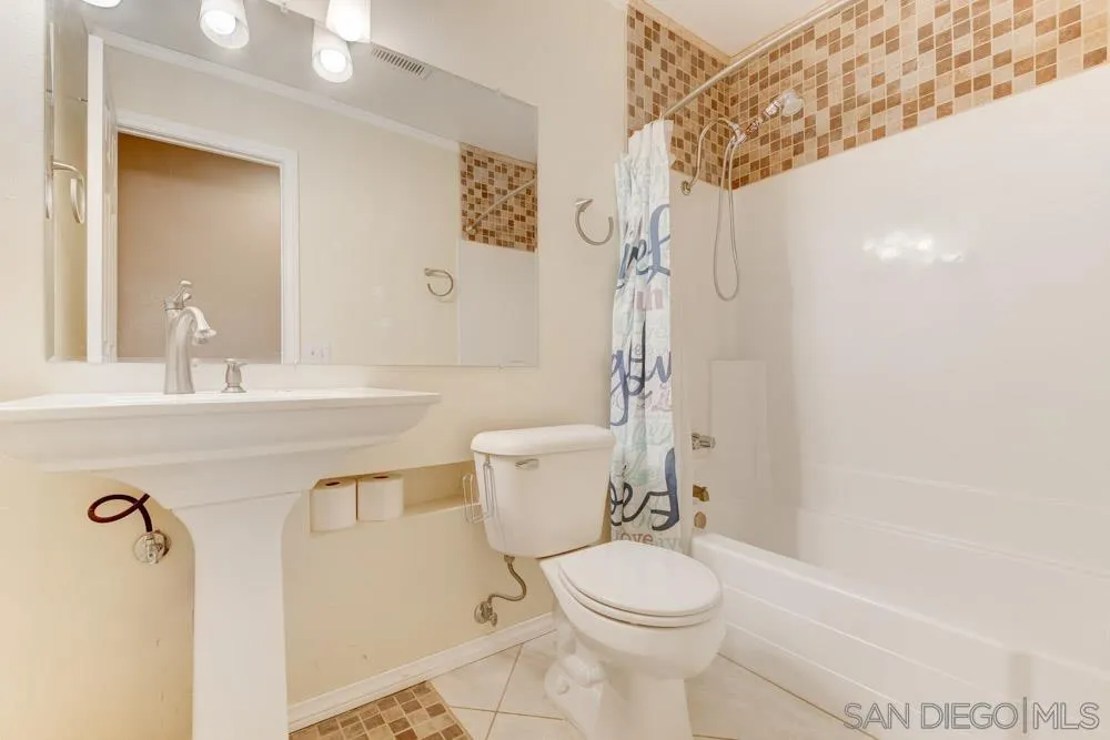 13008 Acton Avenue Poway, CA 92064 - Photo 17 of 28 a bathroom with a sink a toilet and shower