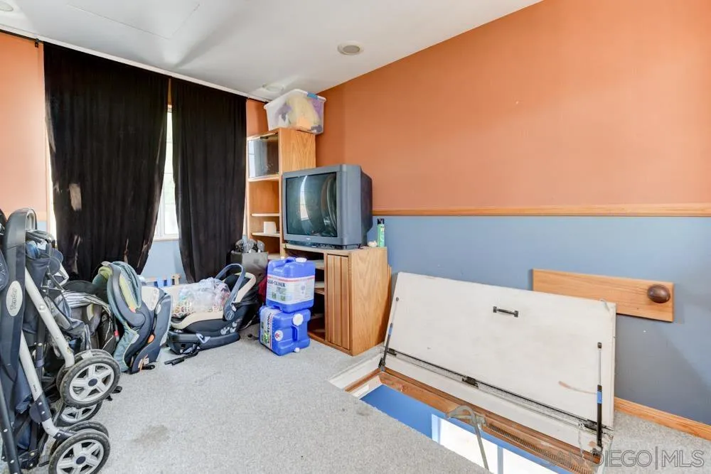 13008 Acton Avenue Poway, CA 92064 - Photo 18 of 28 a room with furniture and a flat screen tv