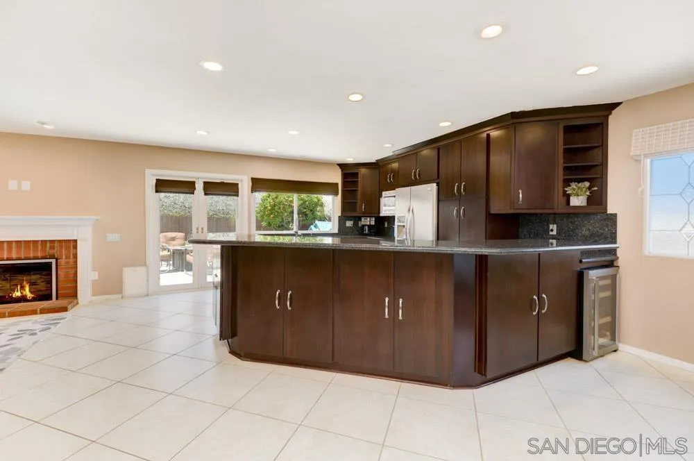 13008 Acton Avenue Poway, CA 92064 - Photo 4 of 28 a kitchen with stainless steel appliances granite countertop a refrigerator a sink and a stove