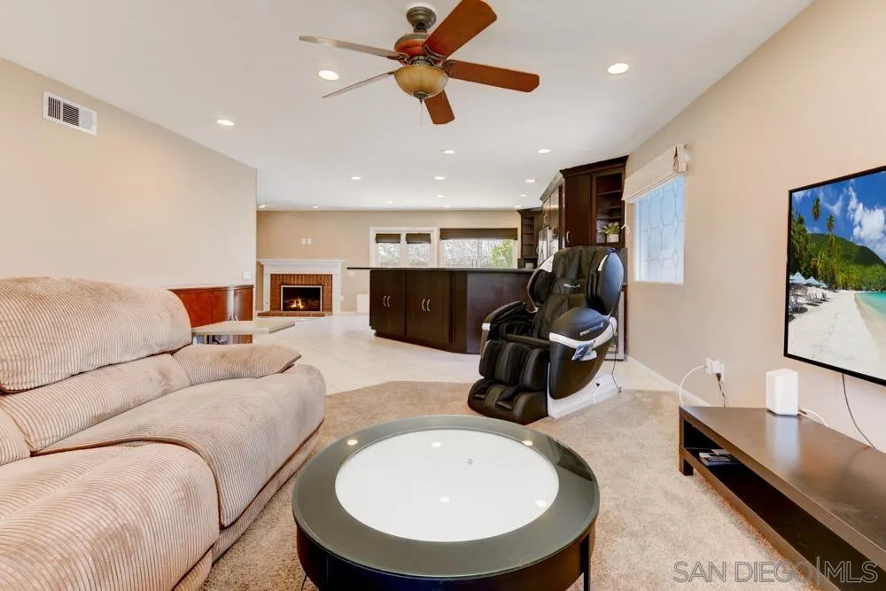 13008 Acton Avenue Poway, CA 92064 - Photo 10 of 28 a living room with furniture and a flat screen tv