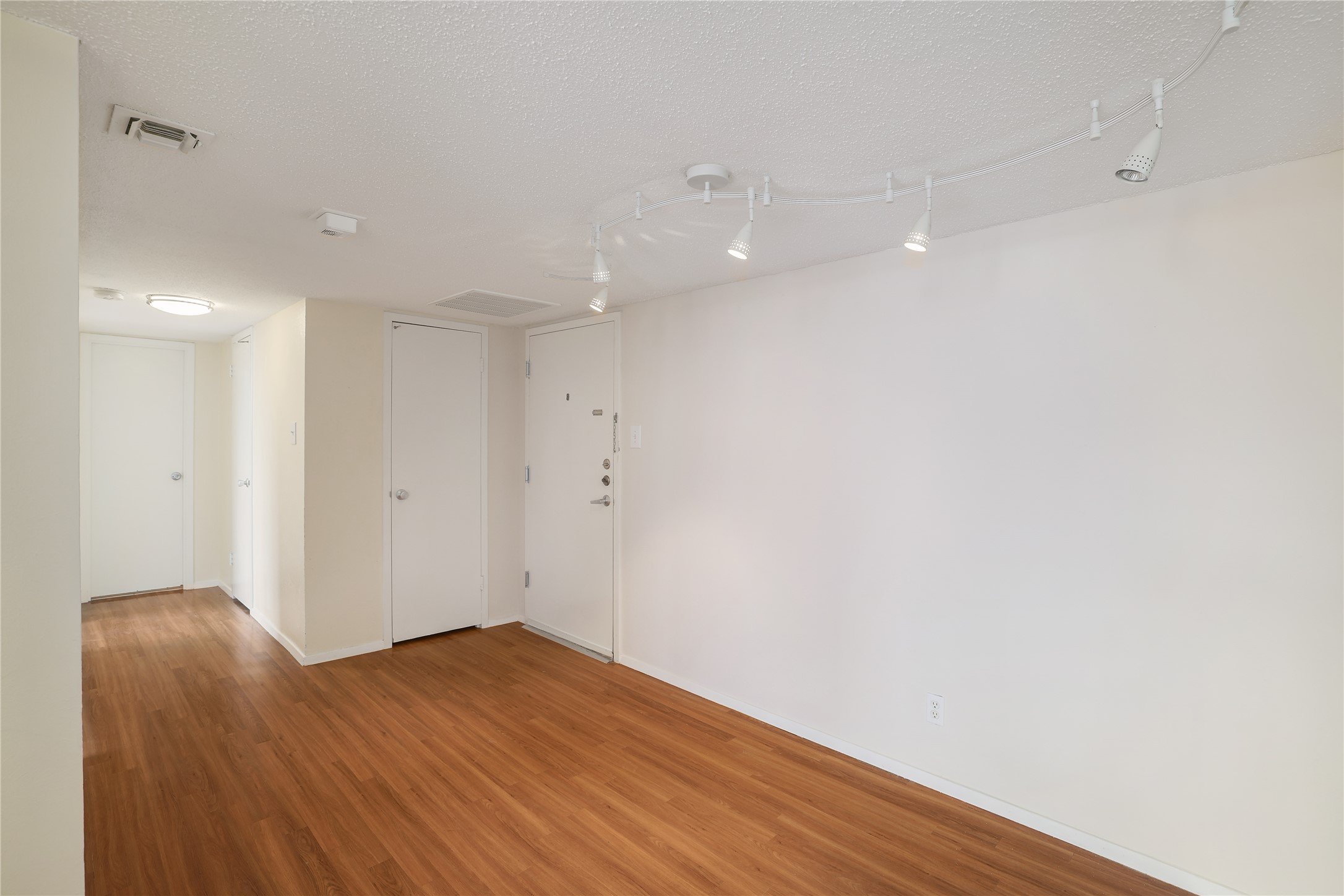 1800 Lavaca Street, Unit A508 Austin, TX 78701 - Photo 11 of 25 The property features rich wood laminate flooring and track lighting