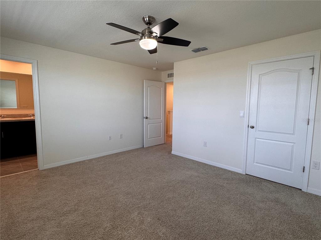 2095 King Ranch Street Kissimmee, FL 34744 - Photo 12 of 17 an empty room with closet and a ceiling fan