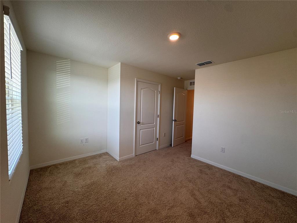 2095 King Ranch Street Kissimmee, FL 34744 - Photo 15 of 17 an empty room with an entryway and closet in it
