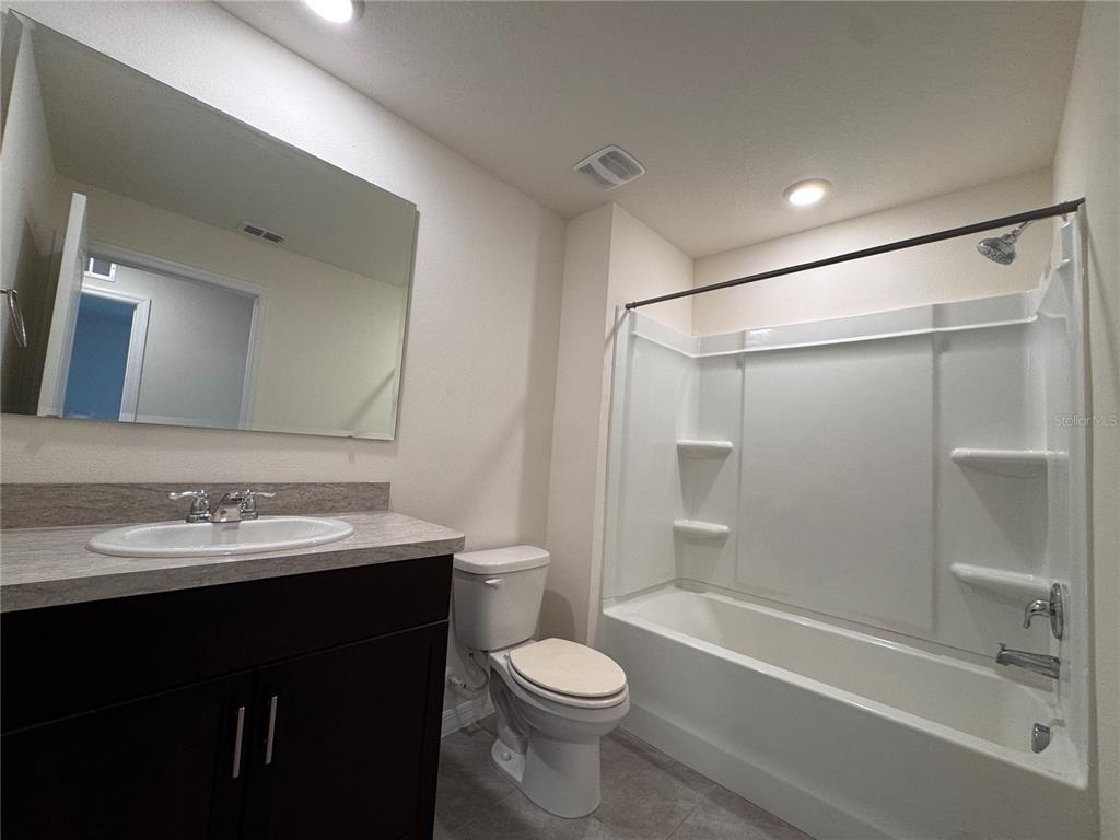 2095 King Ranch Street Kissimmee, FL 34744 - Photo 16 of 17 a bathroom with a sink toilet vanity and shower