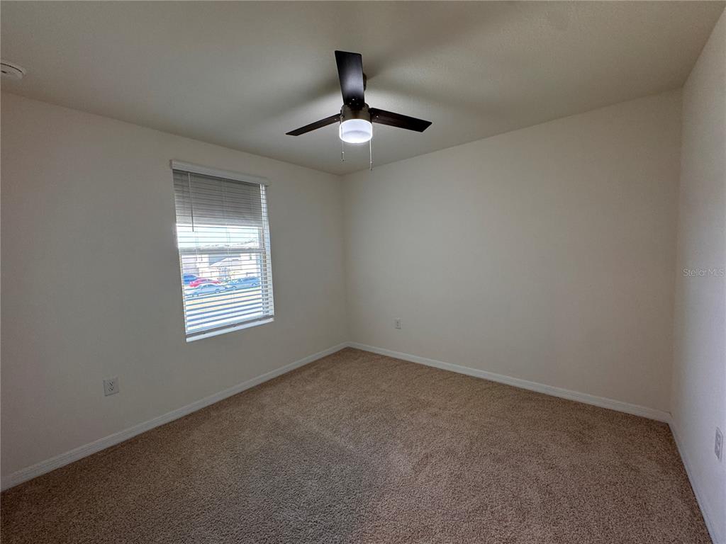 2095 King Ranch Street Kissimmee, FL 34744 - Photo 17 of 17 an empty room with ceiling fan and window