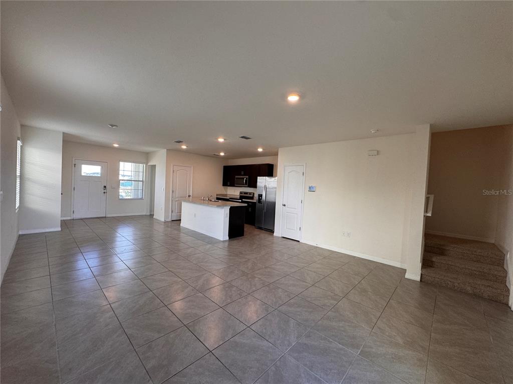 2095 King Ranch Street Kissimmee, FL 34744 - Photo 2 of 17 a view of empty room with kitchen and window