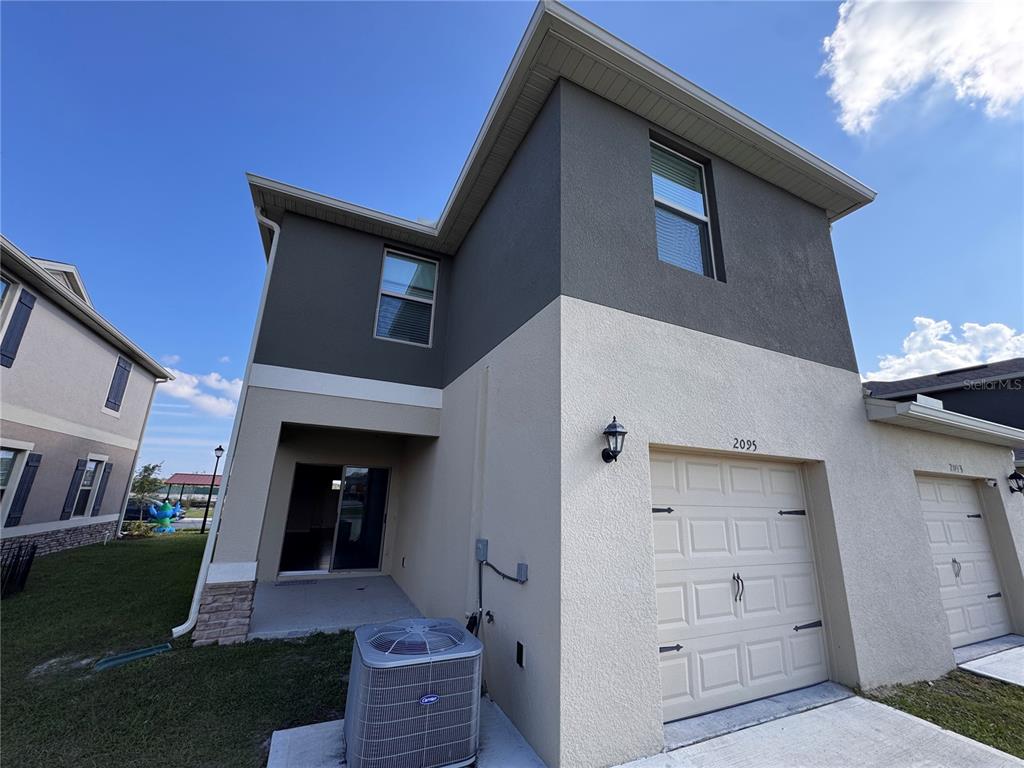 2095 King Ranch Street Kissimmee, FL 34744 - Photo 7 of 17 a view of a house with a yard