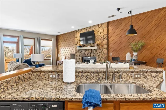 a kitchen with granite countertop a stove and cabinets