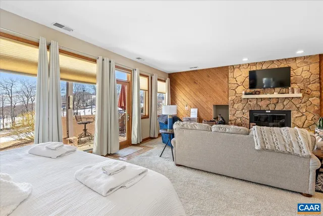 a living room with furniture a flat screen tv and a fireplace