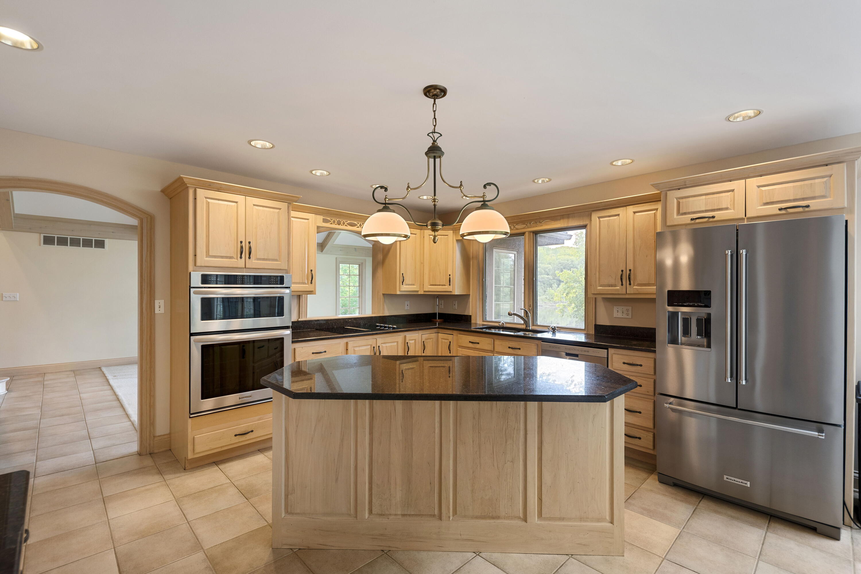 3611 West Waverly Road La Porte, IN 46350 - Photo 15 of 40 a kitchen with granite countertop a refrigerator and a stove top oven