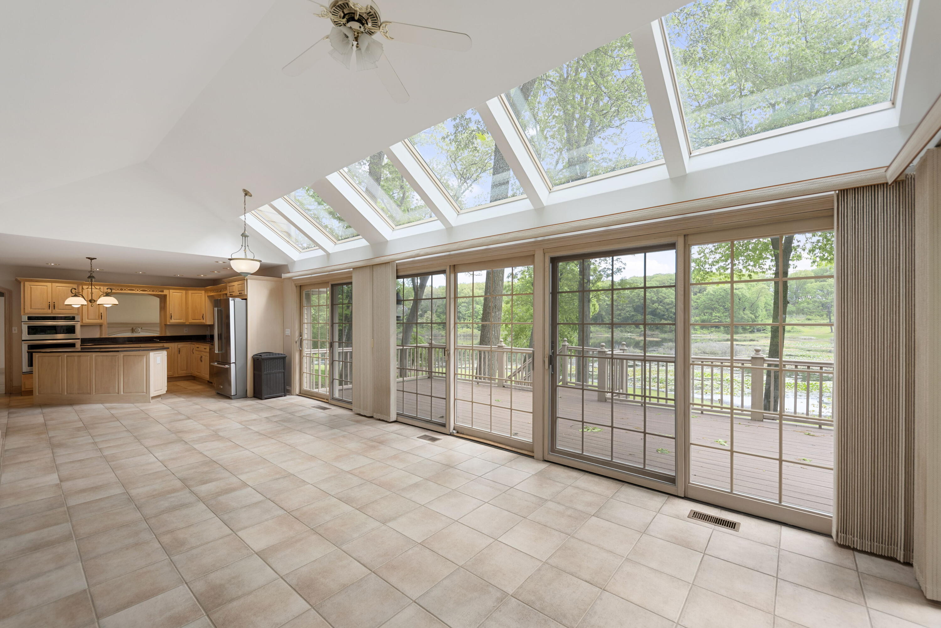 3611 West Waverly Road La Porte, IN 46350 - Photo 19 of 40 a view of an empty room with a floor to ceiling window and a kitchen