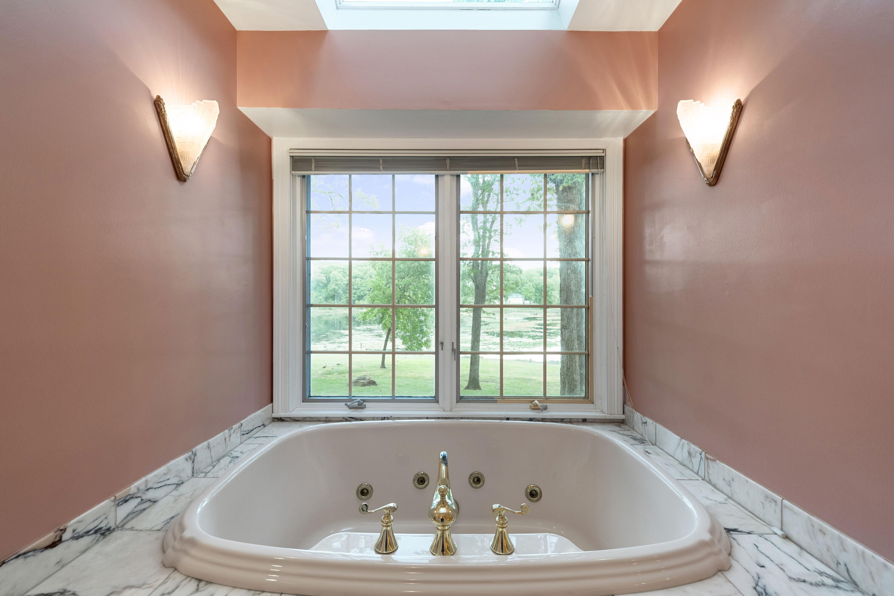 3611 West Waverly Road La Porte, IN 46350 - Photo 26 of 40 a white bath tub sitting in a bathroom next to a window