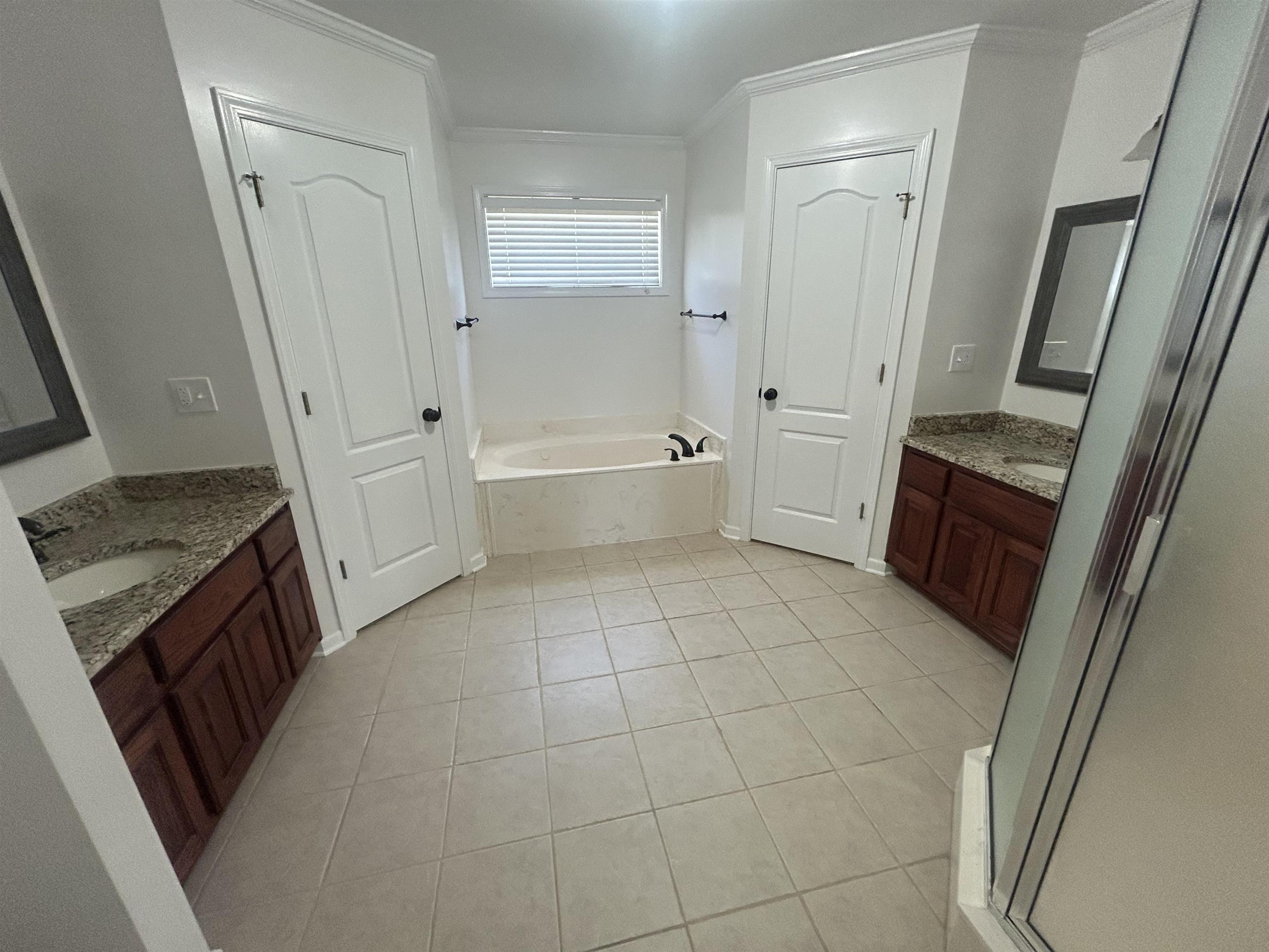 9958 Idaville Road Atoka, TN 38004 - Photo 12 of 20 Bathroom featuring two vanities, light tile patterned floors, a bath, and ornamental molding