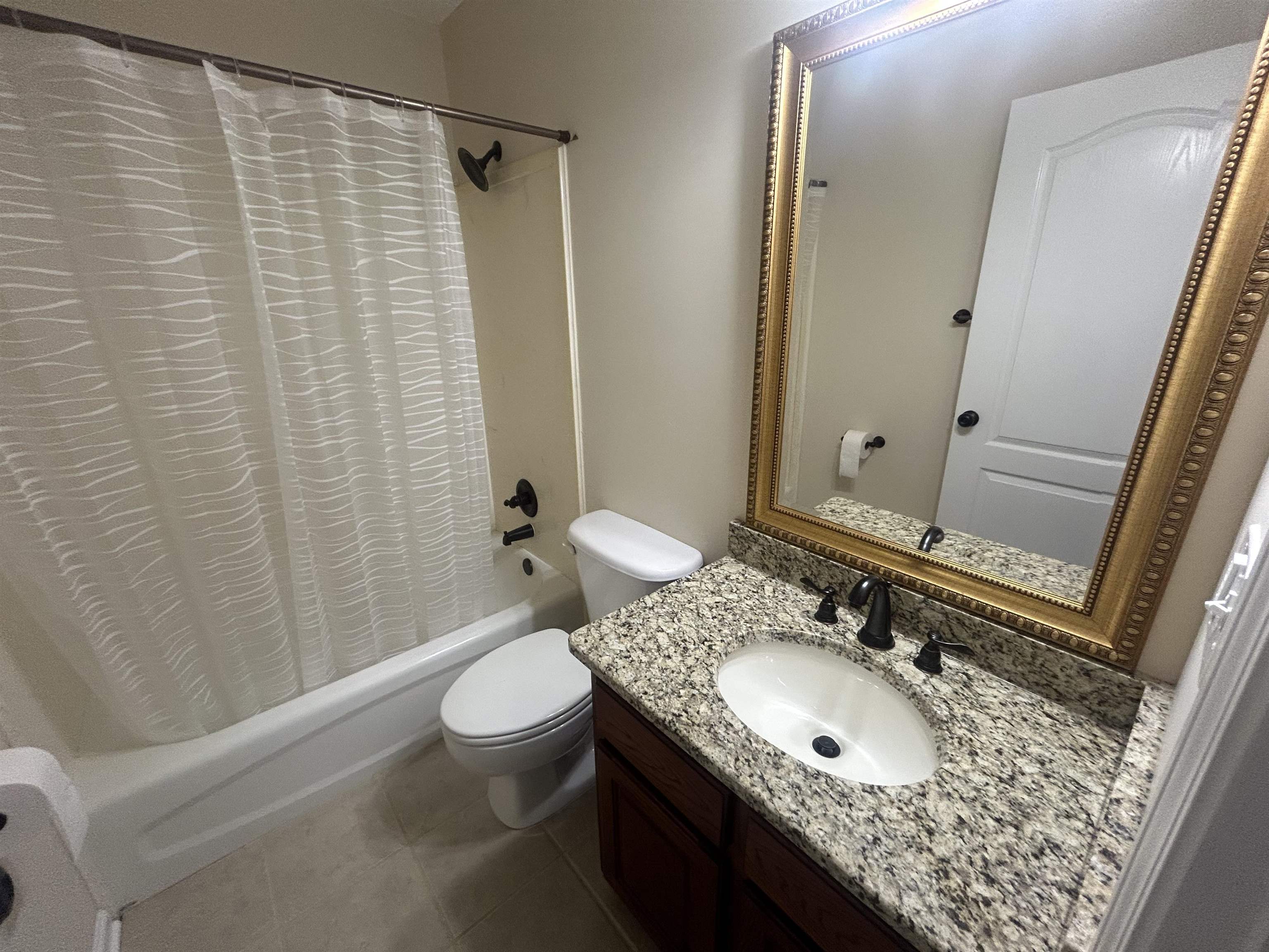 9958 Idaville Road Atoka, TN 38004 - Photo 16 of 20 Bathroom featuring shower / tub combo, vanity, and dark tile patterned flooring