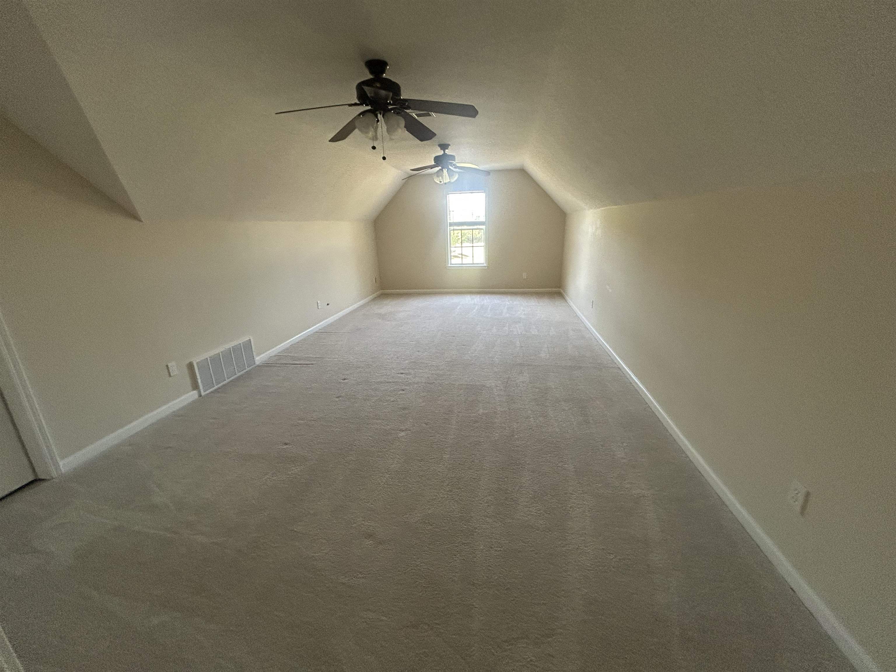 9958 Idaville Road Atoka, TN 38004 - Photo 18 of 20 Bonus room featuring a ceiling fan, vaulted ceiling, and carpet floors