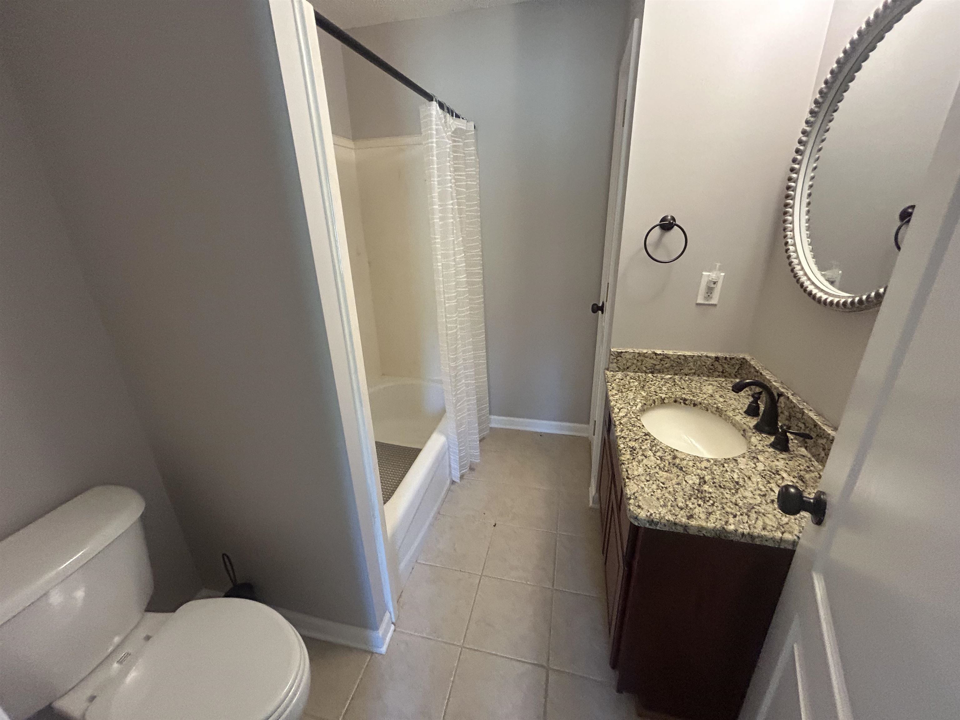 9958 Idaville Road Atoka, TN 38004 - Photo 8 of 20 Bathroom featuring light tile patterned floors, vanity, and shower / bath combo