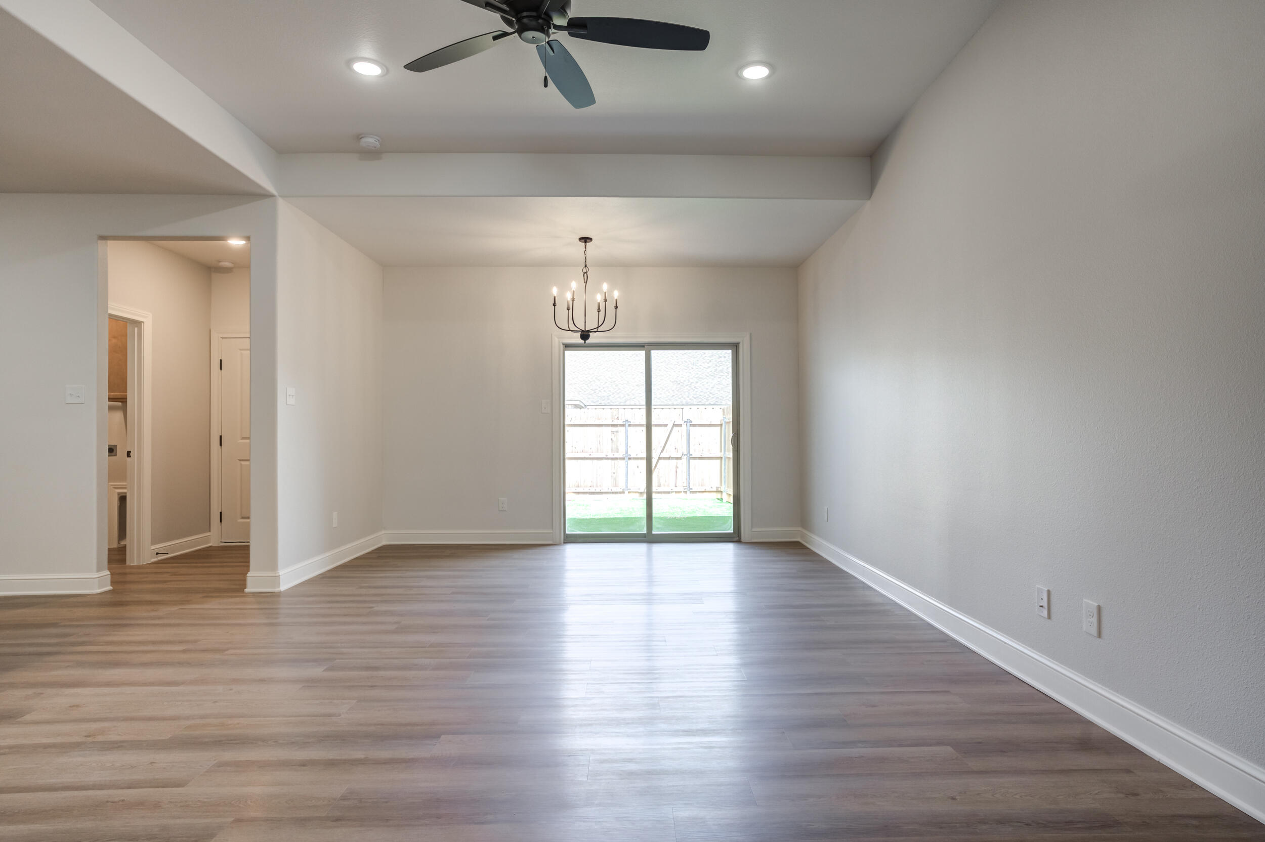 2534 137th Street Lubbock, TX 79423 - Photo 12 of 46 wooden floor in an empty room with a window