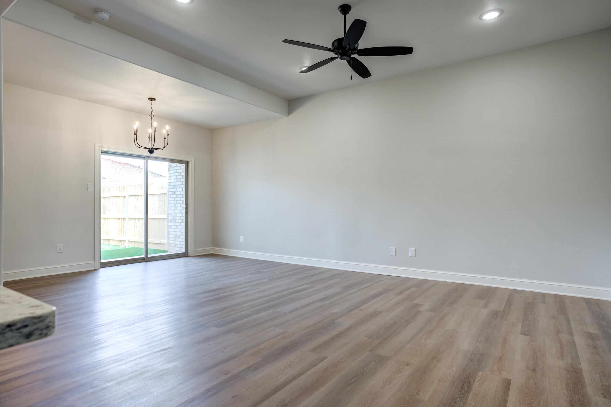 2534 137th Street Lubbock, TX 79423 - Photo 19 of 46 an empty room with wooden floor fan and windows