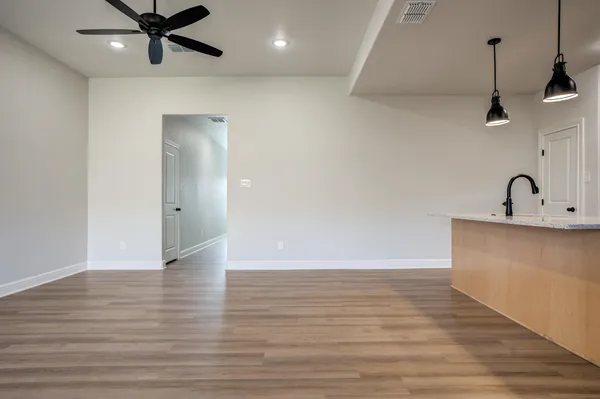 a view of an empty room and wooden floor