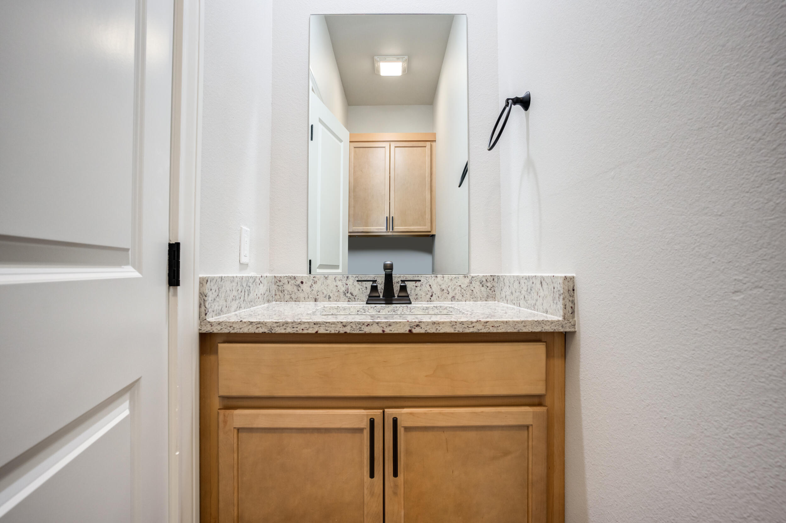 2534 137th Street Lubbock, TX 79423 - Photo 26 of 46 a bathroom with a granite countertop sink and a mirror