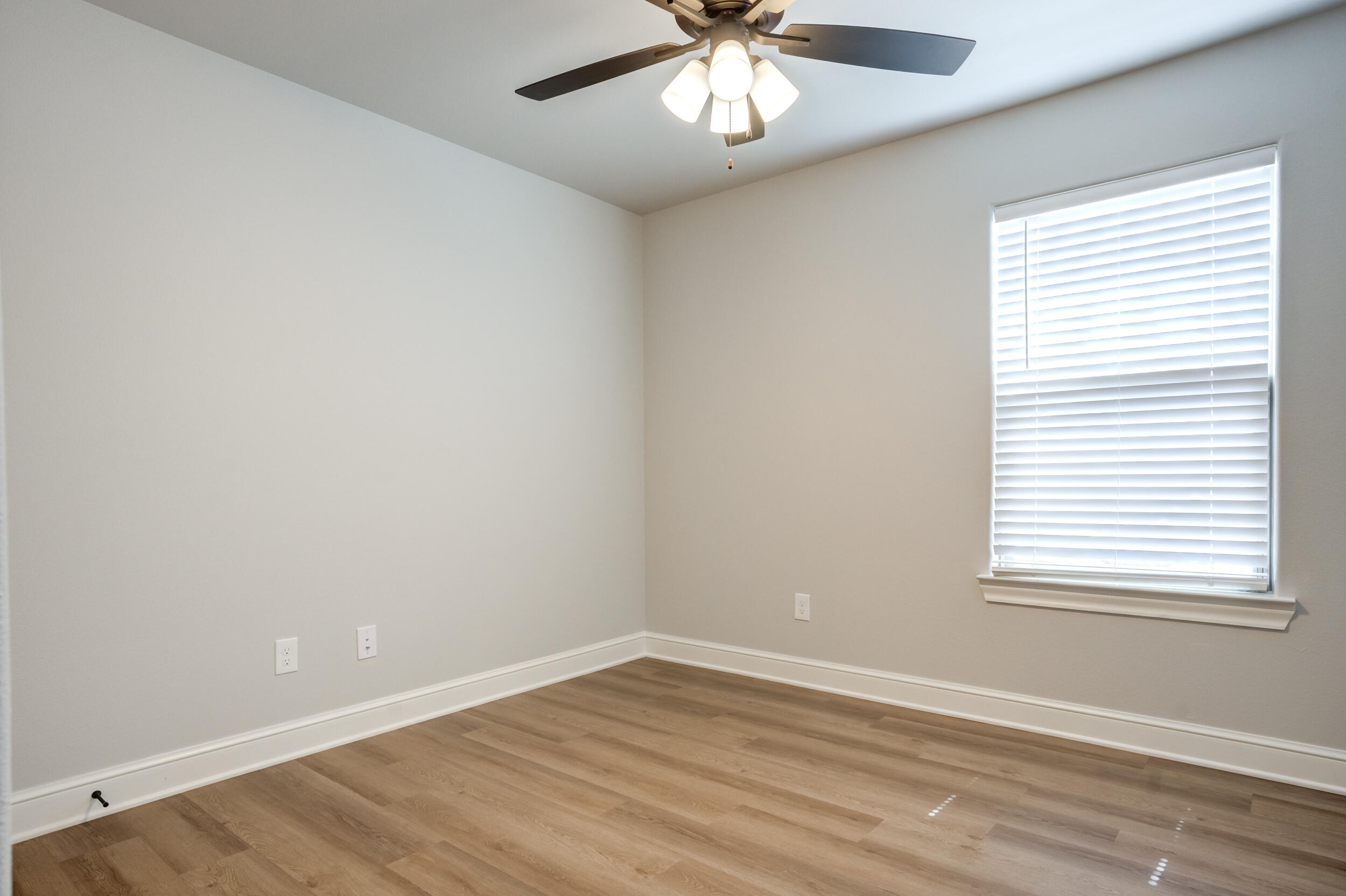 2534 137th Street Lubbock, TX 79423 - Photo 31 of 46 an empty room with wooden floor and windows
