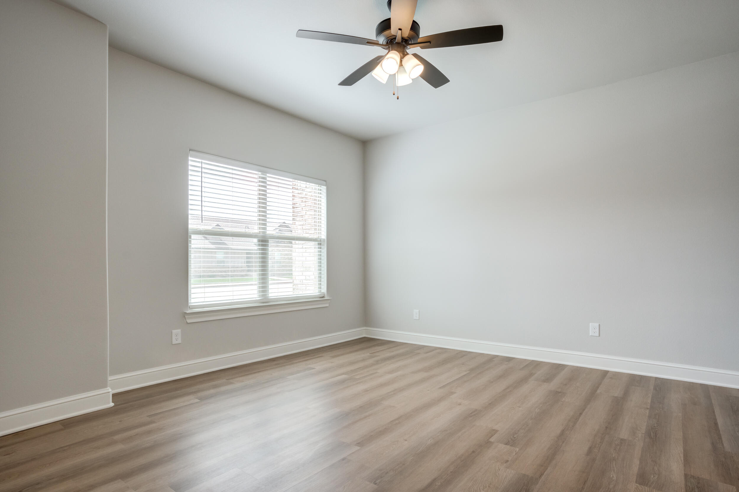 2534 137th Street Lubbock, TX 79423 - Photo 33 of 46 an empty room with wooden floor fan and windows