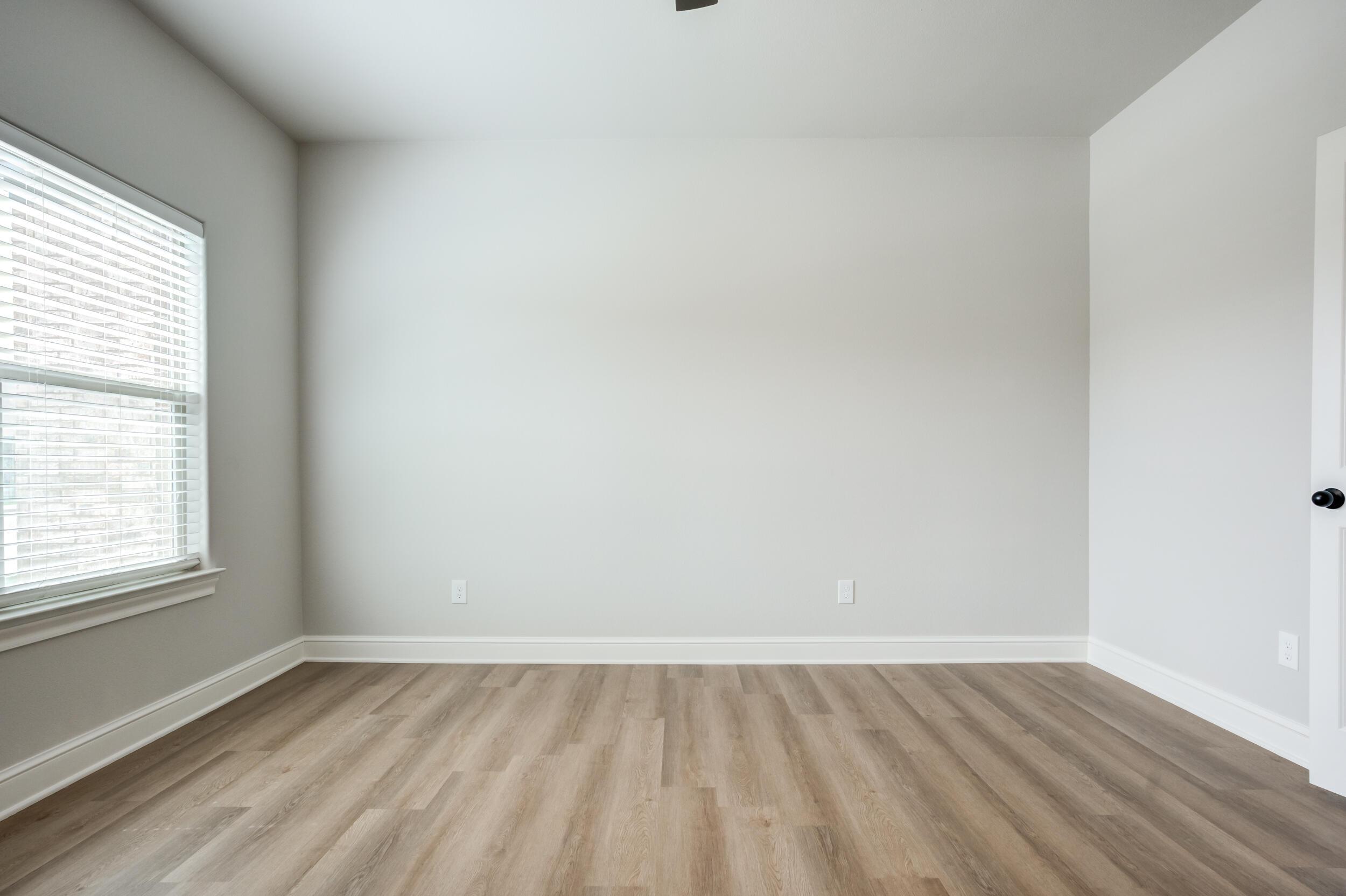 2534 137th Street Lubbock, TX 79423 - Photo 34 of 46 an empty room with a hardwood and windows